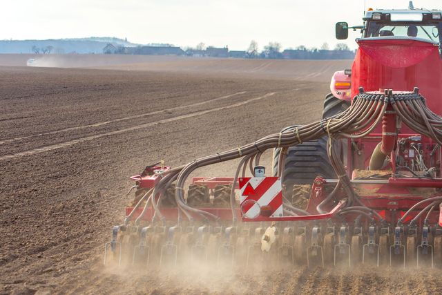 restored tractor ploughing a field